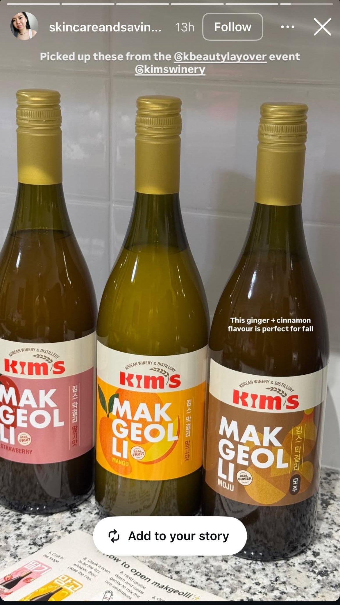 Three bottles of Kim's Makgeolli including Strawberry, Mango, and Moju (ginger and cinnamon) on a countertop with text recommending moju is perfect for fall.